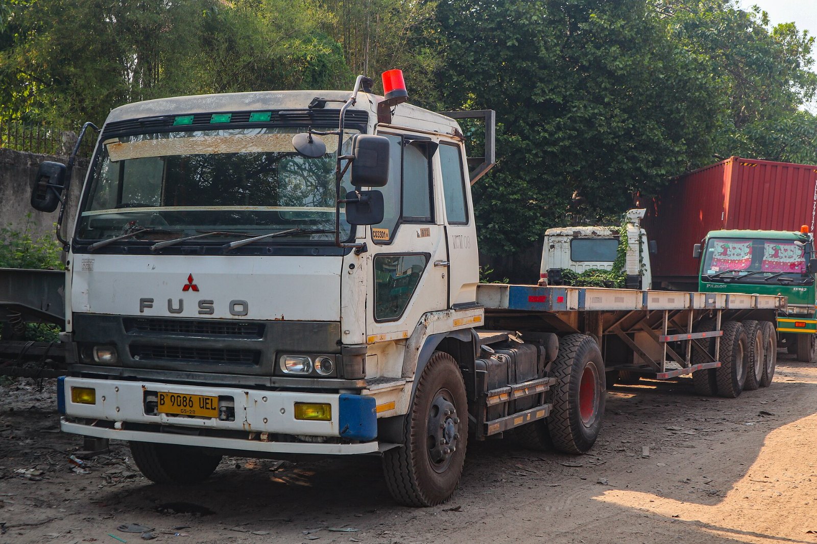 Mitsubishi Fuso truck with a flatbed trailer